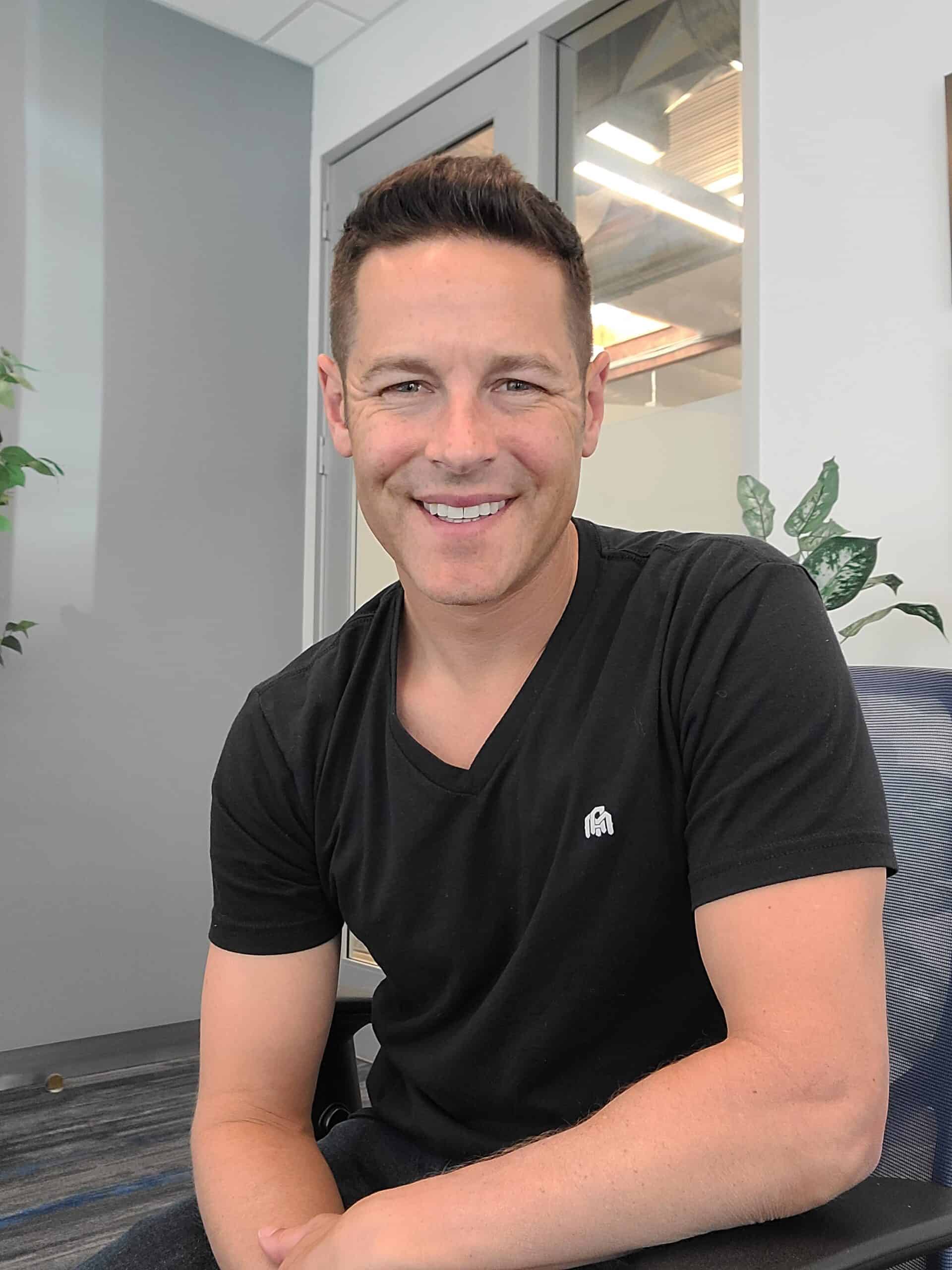 John Lincoln smiling in his office
